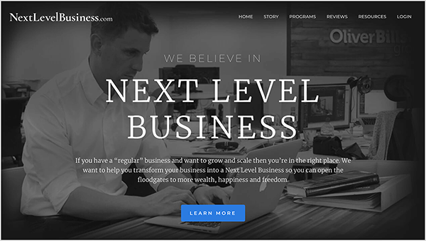 Esta es una captura de pantalla del sitio web de Next Level Business, una empresa dirigida por Oli Billson. En la parte superior izquierda está el nombre del sitio web en texto blanco, NextLevelBusiness.com. En la parte superior derecha están las opciones de navegación en texto blanco. Las opciones son Inicio, Historia, Programas, Recursos de reseñas e Iniciar sesión. En el centro de la página, en texto blanco, un encabezado dice: "Creemos en el negocio del siguiente nivel". Debajo del encabezado hay una breve declaración, "Si tiene un negocio" regular "y desea crecer y escalar, entonces está en el lugar correcto. Queremos ayudarlo a transformar su negocio en un negocio de siguiente nivel para que pueda abrir las compuertas a más riqueza, felicidad y libertad ". En la parte inferior de la página hay un botón azul con texto blanco con la etiqueta "Aprender Más". El fondo de la página web es una foto en blanco y negro de un hombre blanco con pelo corto sentado en un escritorio escribiendo en una computadora portátil Apple. Lleva una camisa blanca de botones y un reloj en la muñeca izquierda. Sobre el escritorio hay un libro apilado sobre una carpeta blanca. Está sentado en un entorno de oficina abierta con otros escritorios y computadoras.