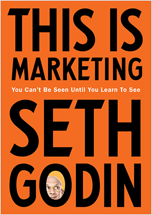 Esta es una captura de pantalla de la portada de This Is Marketing de Seth Godin. La portada es un rectángulo vertical con fondo naranja y texto negro. Una foto de la cabeza de Seth aparece en la O de su apellido.